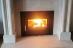 A lighting Henley Eco c550 installed in a white/grey marble fireplace