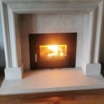 A lighting Henley Eco c550 installed in a white/grey marble fireplace