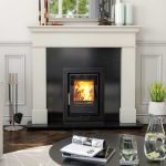 A lighting henley Eco c400 casette insert stove set into a black granite and white marble fireplace